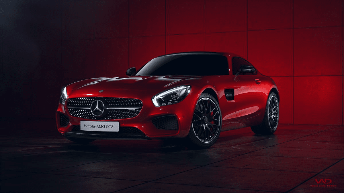 Front view of a dark red Mercedes-AMG GTS sports car parked in front of a red wall